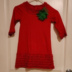Girls holiday red dress complete written ruffles and embellished with a flower